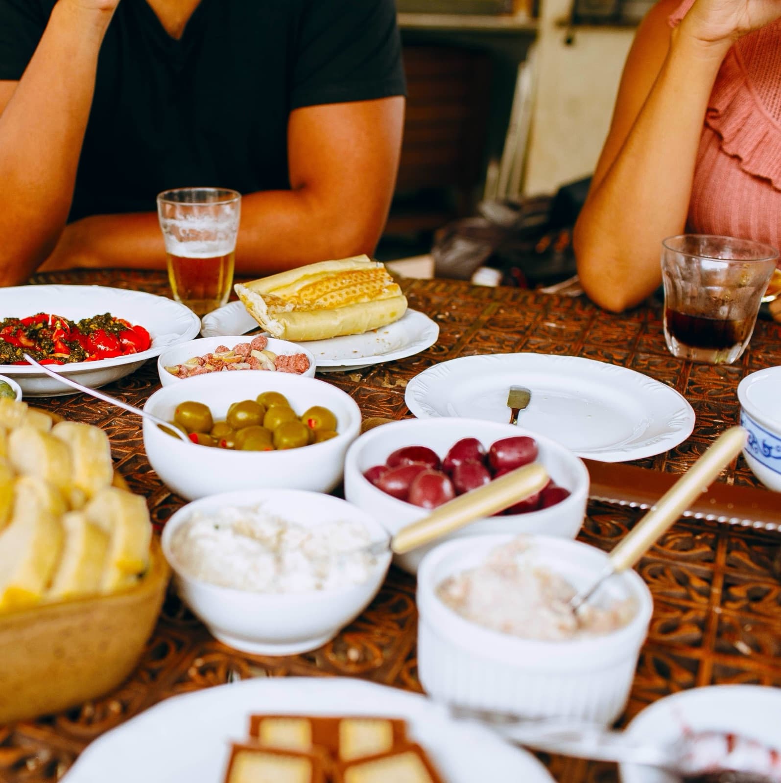 Shared Mediterranean table with small plates and olive oil